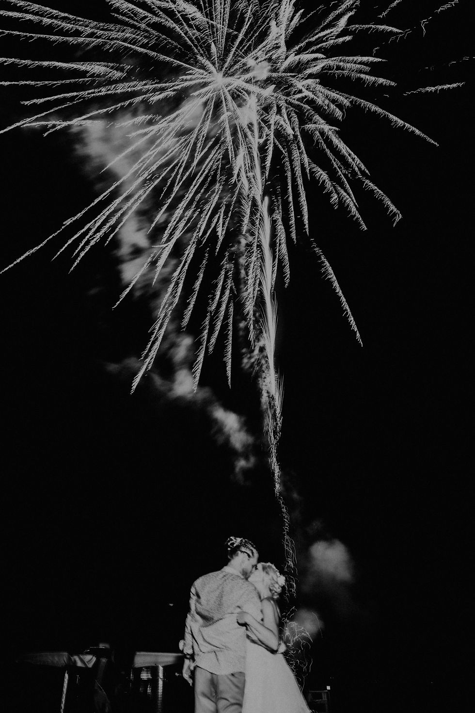 bride and groom kissing under fireworks after wedding in New Hampshire black and white photography