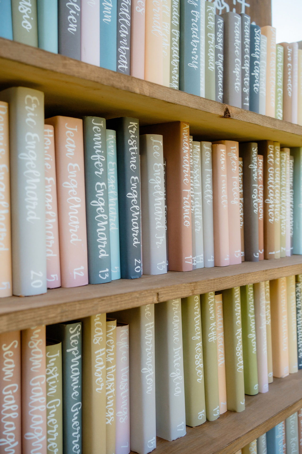 Rows of books with guests' names written on the spines at a wedding in New Hampshire.