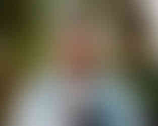 groom fixing his tie and laughing