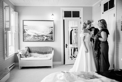 candid wedding photo of the bride getting ready at grey havens inn in georgetown, maine