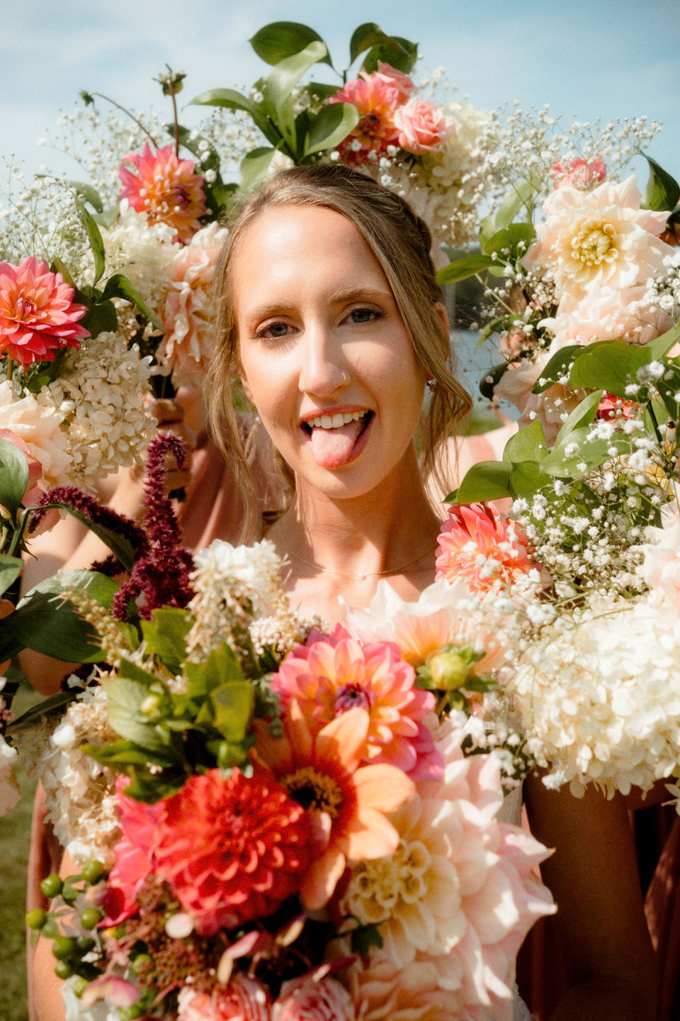 A bride's face surrounded by floral bouquets in southern Maine.