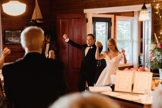 bride and groom entering their reception at grey havens inn in georgetown, maine