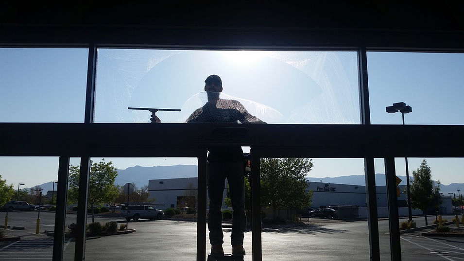 Rocky Mountain Window Cleaners cleaning a commercial window in Albuquerque, NM
