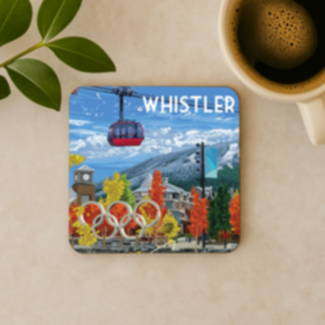 Whistler coaster with Olympic Rings, red gondola, and fall trees in the village