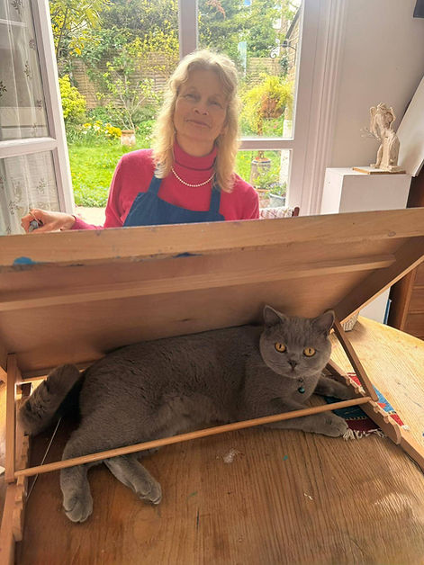 Jane Kemp posing in studio at easel with cat