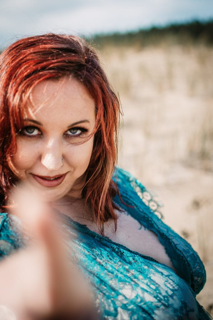 Woman pointing at the camera.