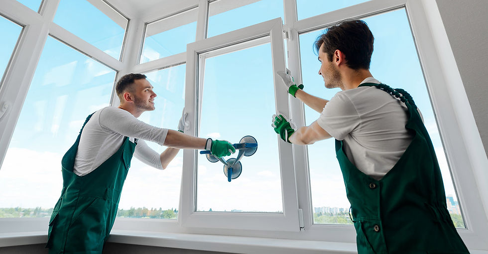 two men in white shirts installing a window