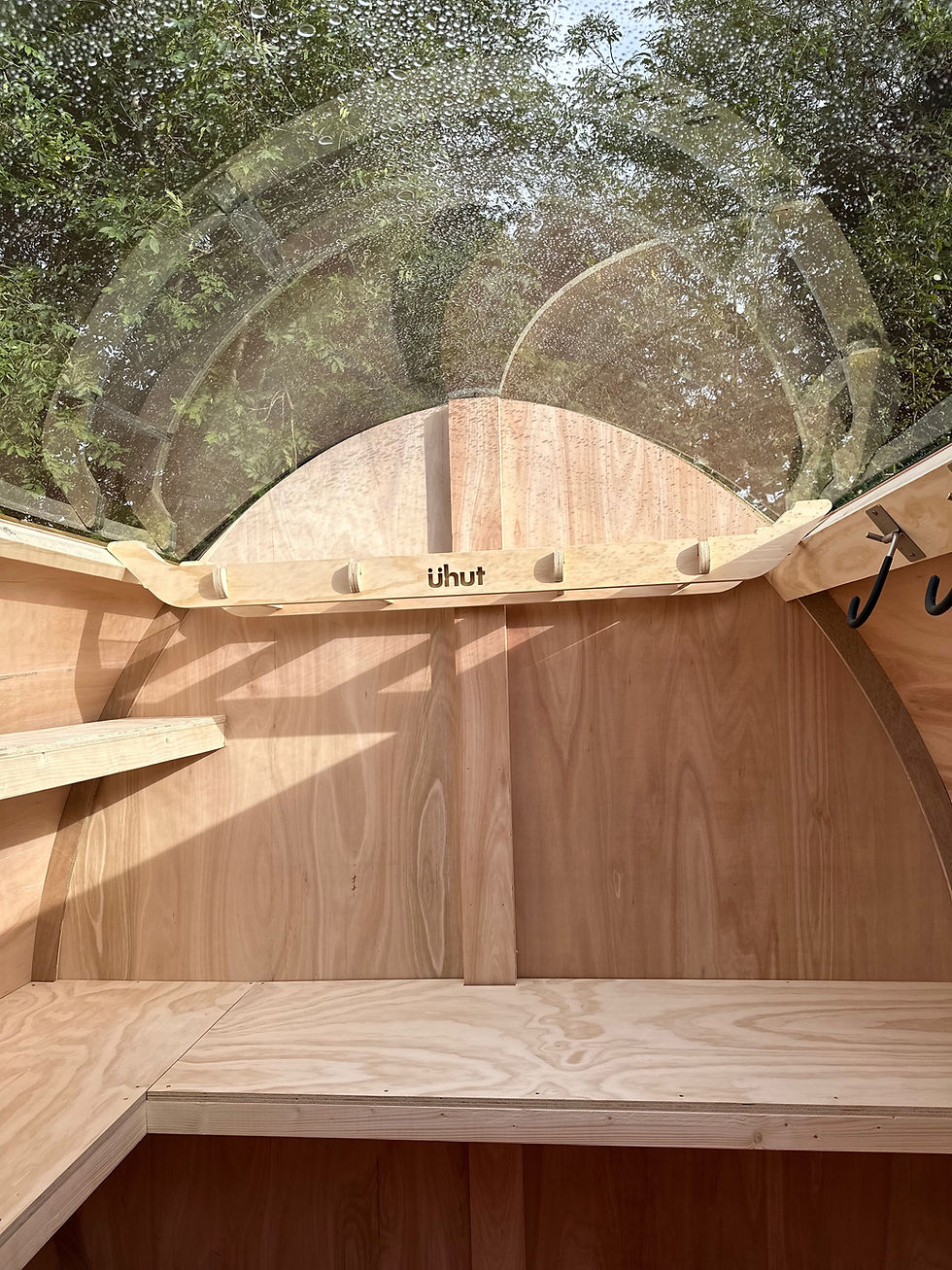 Interior of an 8ft wide shed in Edinburgh with a transparent roof, benches and shelving.