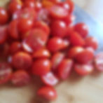A pile of halved cherry tomatoes