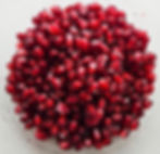 A bowl filled with dark red pomegranate arils