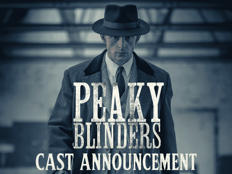 Jamie Bell as Duke Shelby in a hat and coat against a blurred industrial background for the Peaky Blinders sequel series announcement.