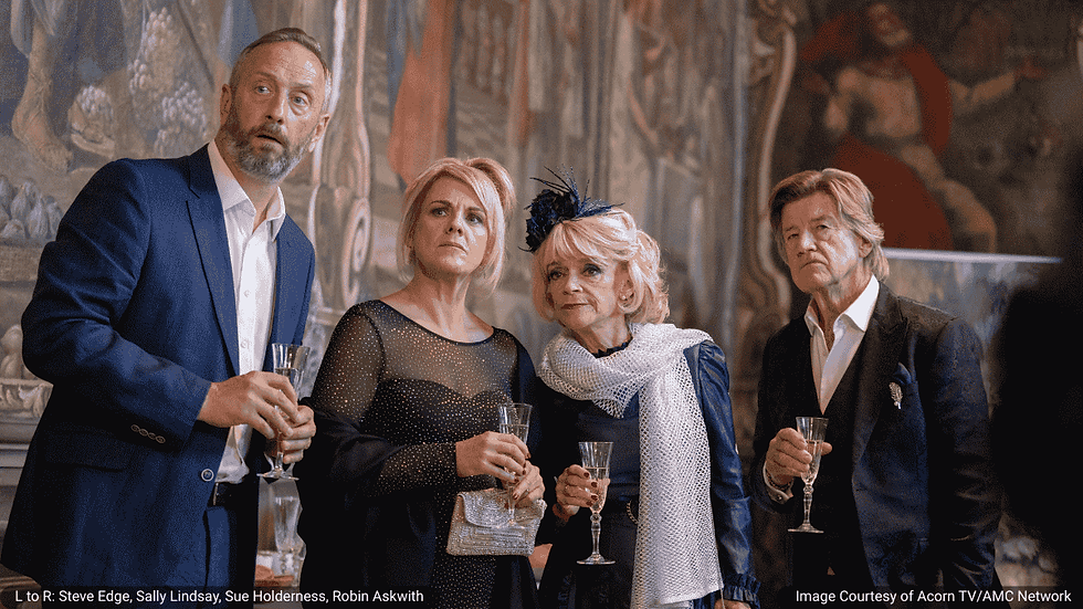 Four actors from The Madame Blanc Mysteries pose indoors with champagne flutes. From left to right: Steve Edge (Dom Hayfield), Sally Lindsay (Jean White), Sue Holderness (Judith Lloyd-James), and Robin Askwith (Jeremy Lloyd-James).