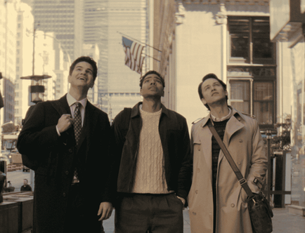 Will Angus, Nicholas DuVernay, and Jack Martin stand together on a sunny Manhattan sidewalk in professional coats and business casual attire.