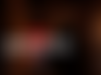 Actor Jeremy Conner as Ghostface in Scream 7 (2026) wearing a black hooded robe and mask while holding a metallic knife in a dark yard.