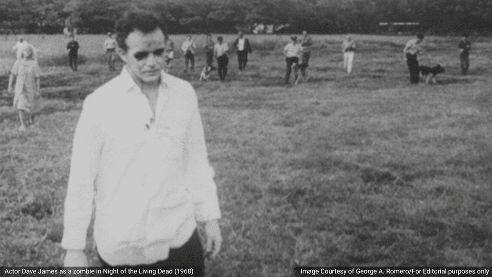 Scene from George A. Romero’s Night of the Living Dead (1968), showing actor Dave James as a zombie in the foreground while other ghouls advance across a field in the background: Image Courtesy of George A. Romero/For Editorial purposes only
