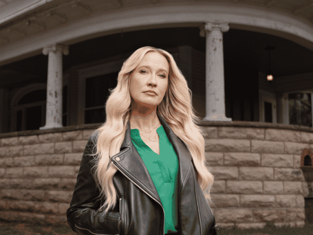 Anna Camp stands outside Bihl Manor in Fremont, Ohio, while hosting HGTV’s competition series A Very Haunted Renovation.