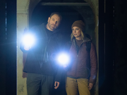 Image of Heather Amaro and Josh Gates discussing a game plan for their investigation of Ireland's Spike Island-ExpeditionX-August2025