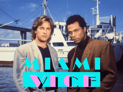Don Johnson and Philip Michael Thomas as Sonny Crockett and Ricardo Tubbs stand in front of a large boat in a scene from Miami Vice.