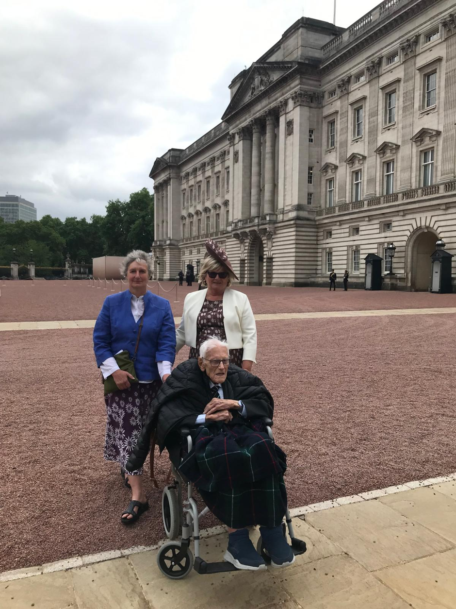 Activities Lead Nicky Perry, Resident of Oaktree Court Care Home Ken, and Ken’s daughter Jane, stood inside the grounds of Buckingham Palace.