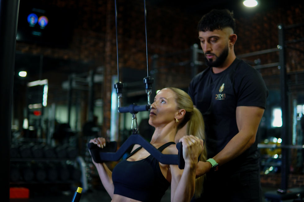 Personal trainer coaching client during strength training session in Canberra gym at D1M1 Fitness