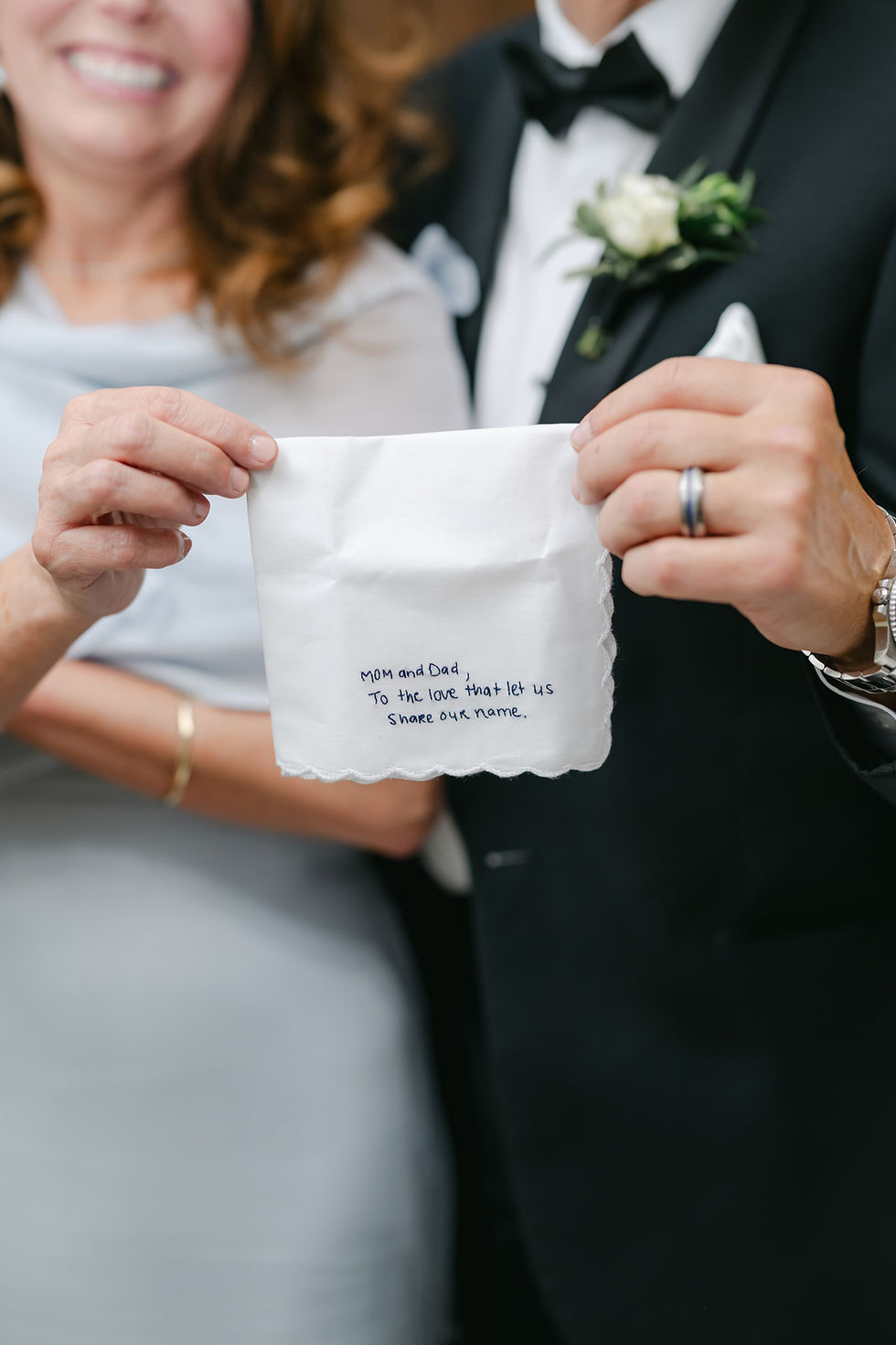 Detail shot of a personalized handkerchief gift for the mother and father of the bride.