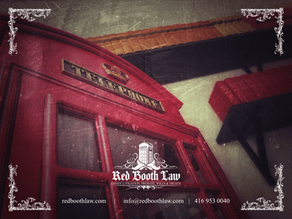 Red telephone booth inside probate lawyer office in Ontario, Canada, with estate administration tax and estate law books on shelf.