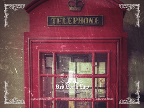 Red vintage telephone booth inside Ontario estate tax lawyer office.