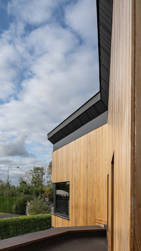 a building with a wooden facade and a black roof