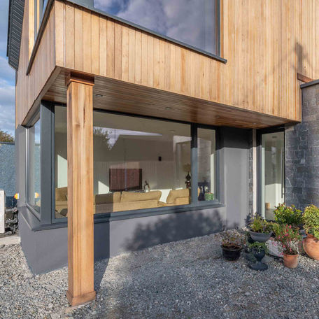 a house with a lot of windows and a couch in the living room