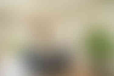 a dining room with a round table and chairs