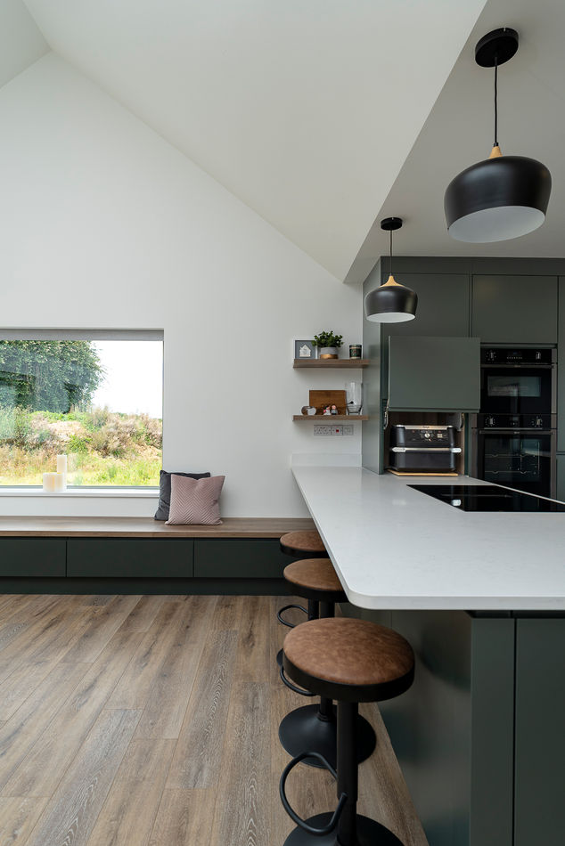 a kitchen with green cabinets and a white counter top