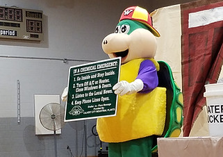 Wally holding sign