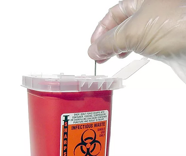 person placing needle in biohazard sharps container