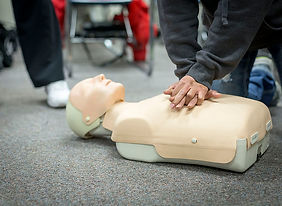 person performing CPR on mannequin