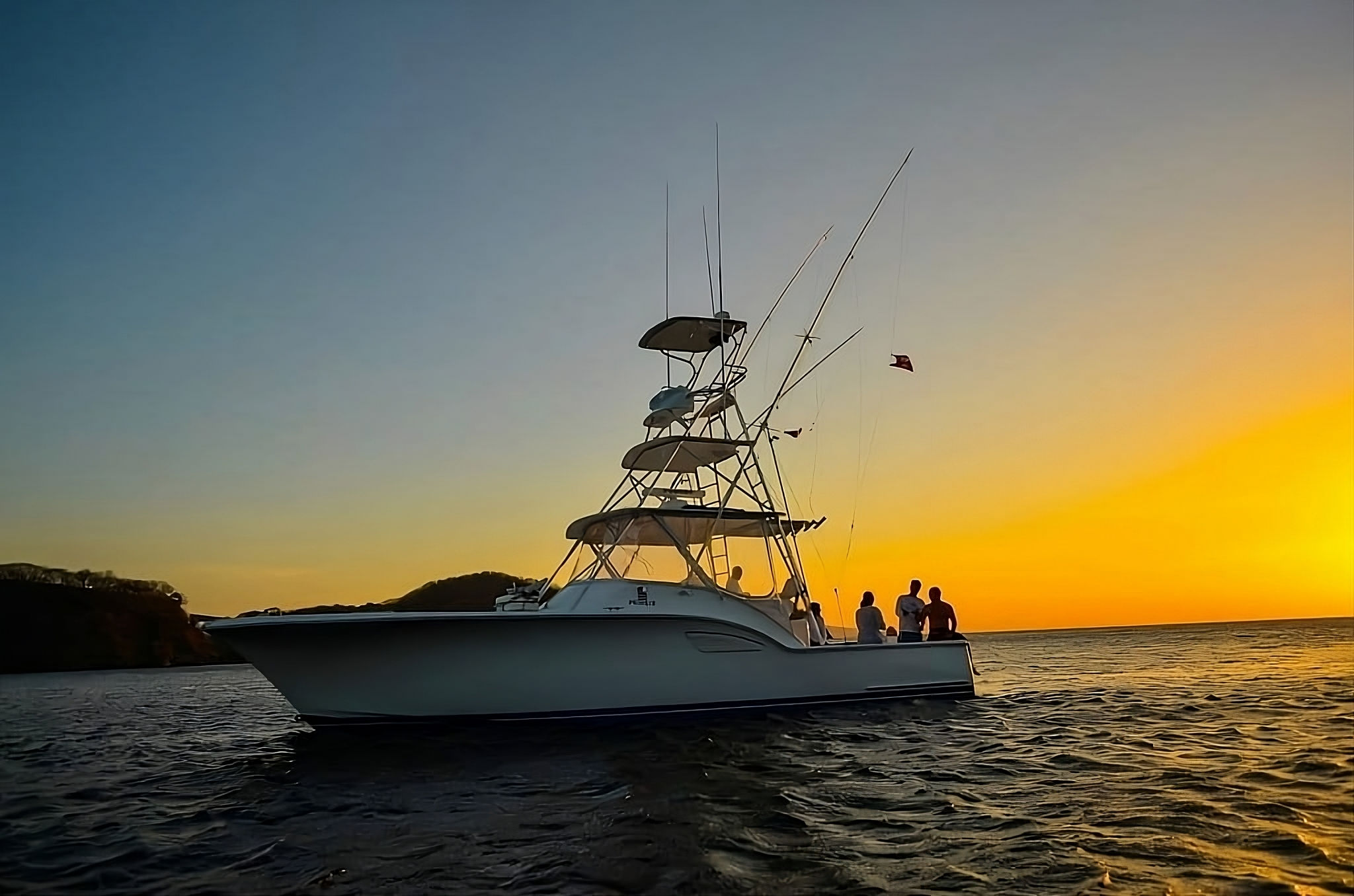 The Out Islander 38’ at sunset, anglers on deck