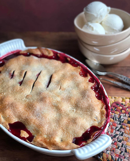 "A golden brown baked blackberry pie made with fresh vanilla, cinnamon, and ginger in a buttery crust."