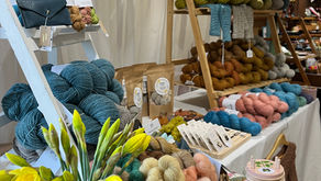 a small stand of hand-dyed yarn at a knitting festival