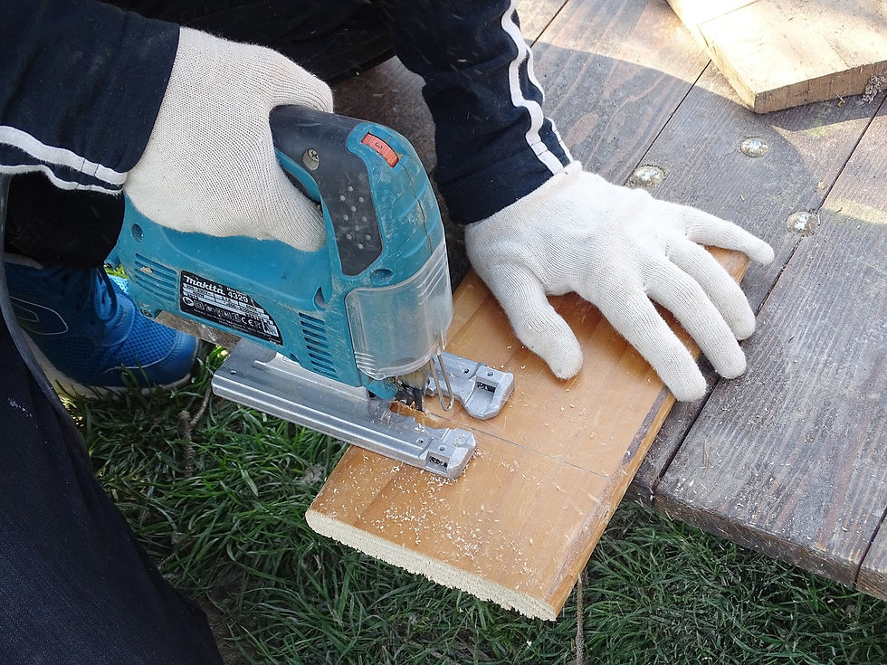 person using a jigsaw to cut a board