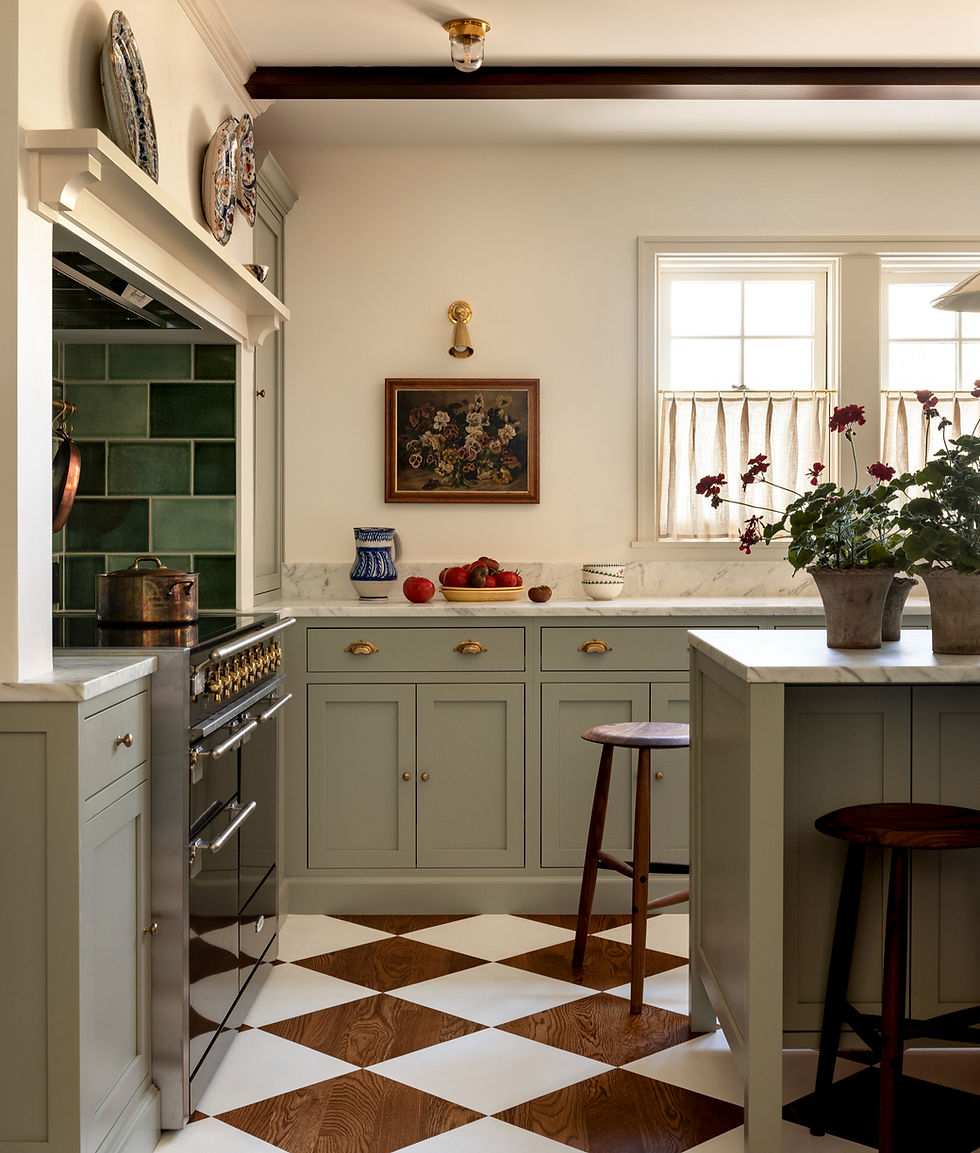 Cozy kitchen with pale green cabinets, a french range, and checkered floor. Sunlight through windows, potted plants, and fruit bowl.