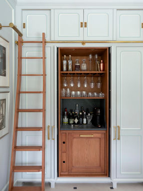 Bespoke kitchen with pale blue custom cabinets,  integrated oak bar and library style ladder