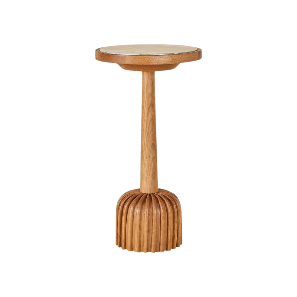Wooden stool with a round top and a fluted base, in natural brown color. Simple and elegant design.