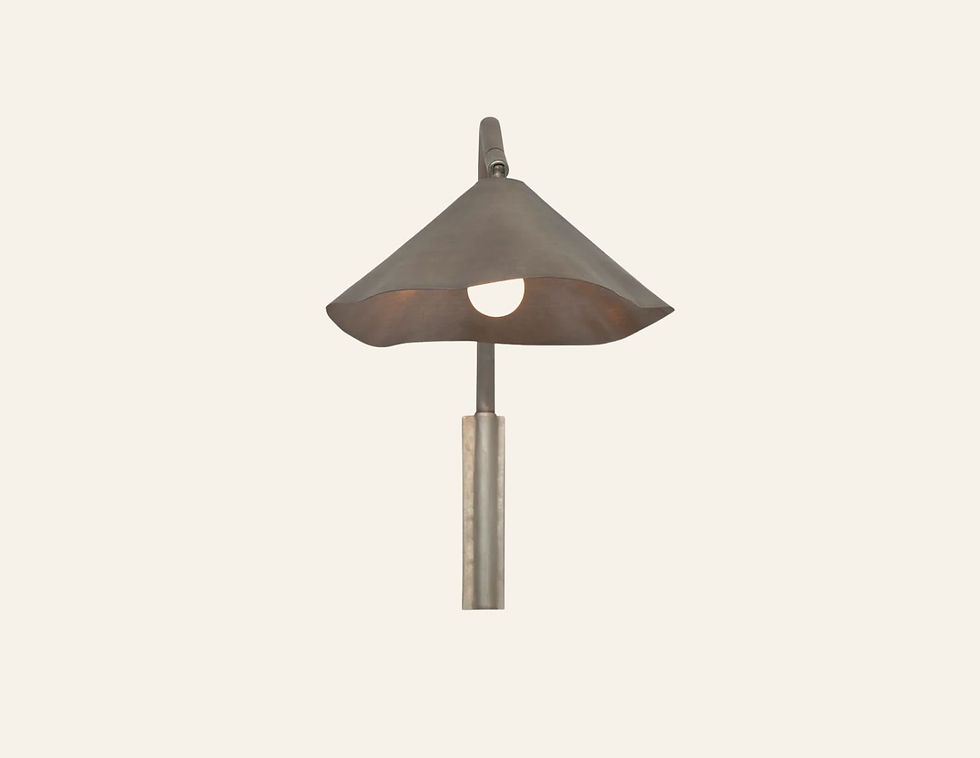 A brushed aliuminum wall-mounted lamp with a conical shade is lit against a plain beige background, creating a minimalist aesthetic.