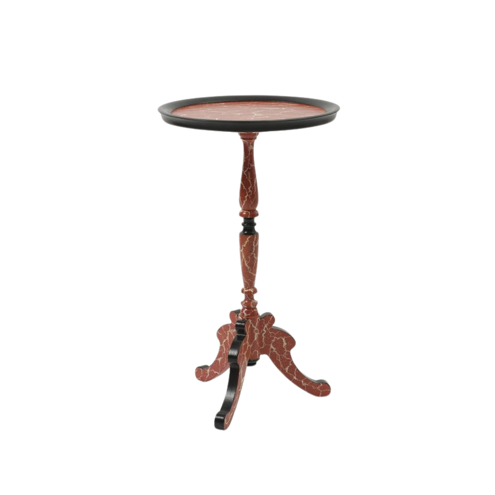 Ornate pedestal table with a round red-marble painted top and decorative black trim. The wooden base has an elegant, intricate design.