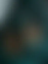 A trio of hand-glazed mushroom-shaped ceramic sculptural lamps with red cords on a dark stairwell.