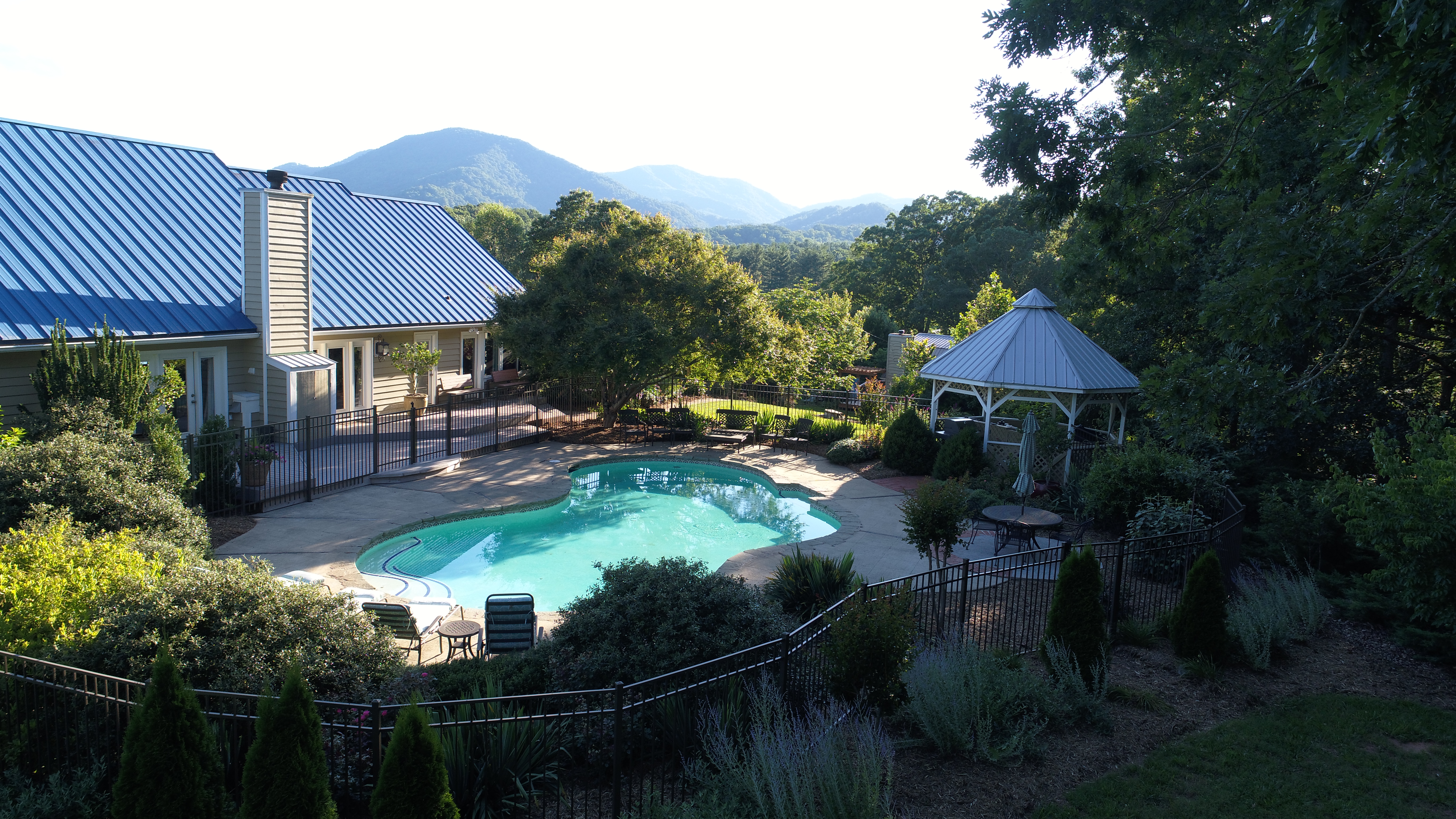 aerial of pool with mountains in the background