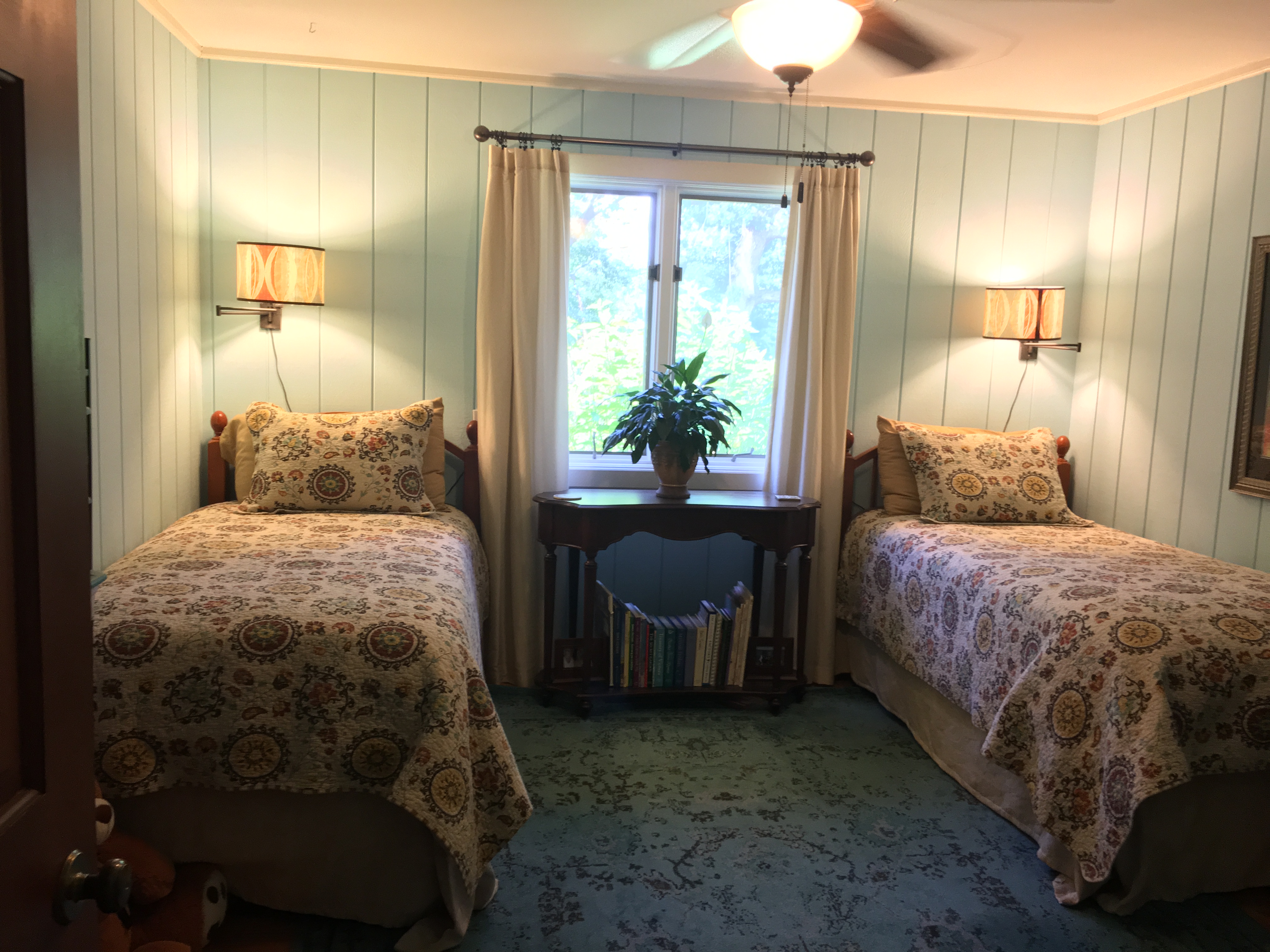 blue bedroom with 2 twin beds