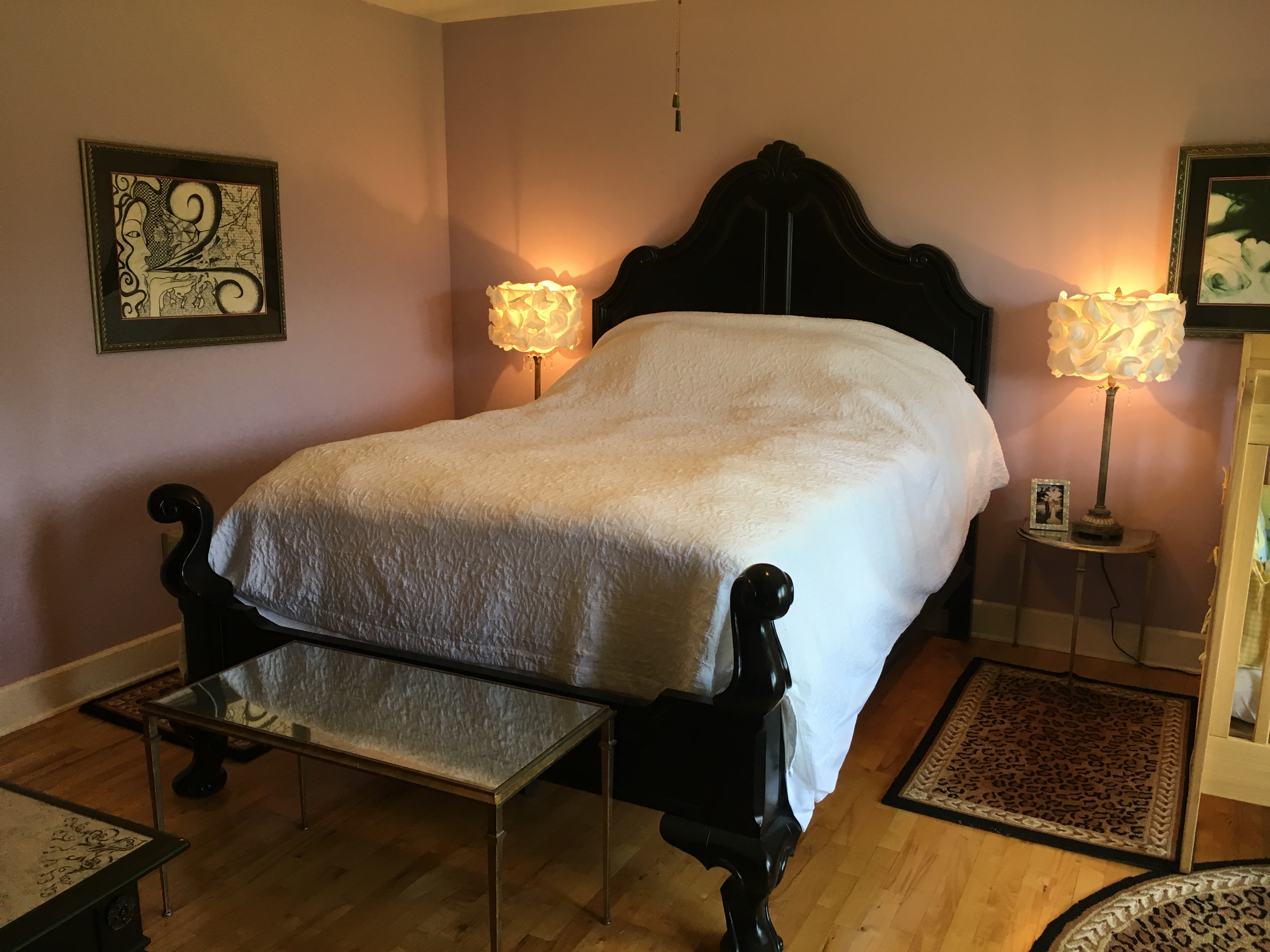 stained glass bedroom with a queen size bed and a baby crib