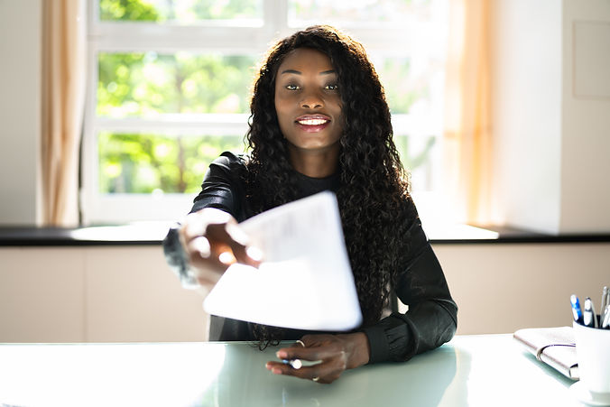 African Business Woman Giving Paycheck Or Payroll Cheque.jpg