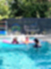 Children and instructor in swimming pool, learning to swim; Little Frogs Swim Sc.