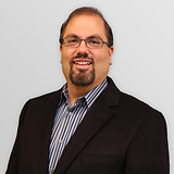Tony-Meluzio_Headshot_grey.jpg